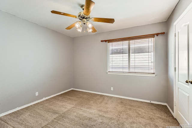 empty room with baseboards, carpet, and a ceiling fan