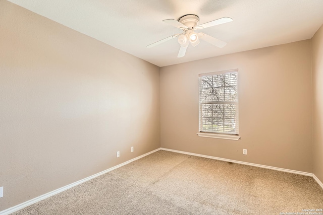 spare room featuring a ceiling fan, baseboards, and carpet floors