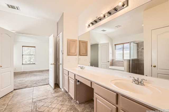 bathroom with a sink, visible vents, double vanity, and tile patterned flooring