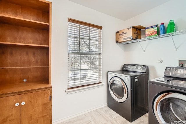 laundry area with washer and dryer, laundry area, and baseboards