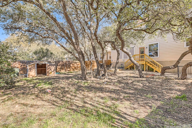 view of yard with stairway and a fenced backyard