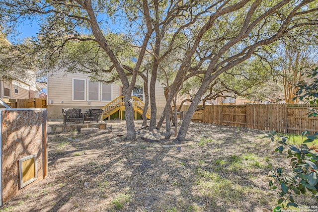 view of yard with stairway and a fenced backyard