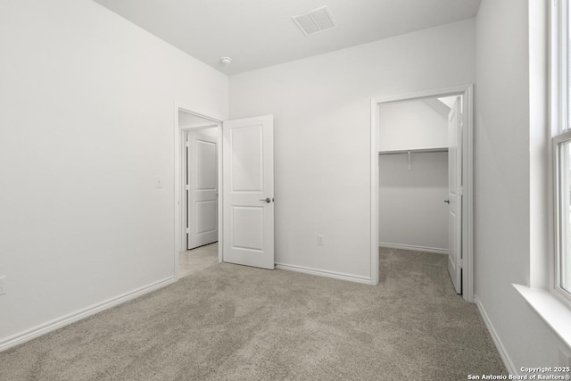 13210 Club House Blvd, San Antonio, TX 78221 - unfurnished bedroom featuring carpet flooring, baseboards, a spacious closet, and a closet