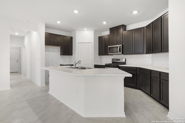 13210 Club House Blvd, San Antonio, TX 78221 - kitchen featuring appliances with stainless steel finishes, a sink, a center island with sink, recessed lighting, and tasteful backsplash