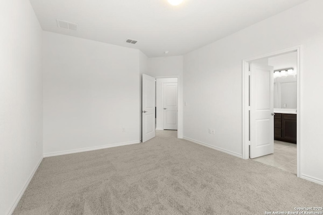 13210 Club House Blvd, San Antonio, TX 78221 - unfurnished bedroom with light colored carpet, baseboards, and ensuite bath