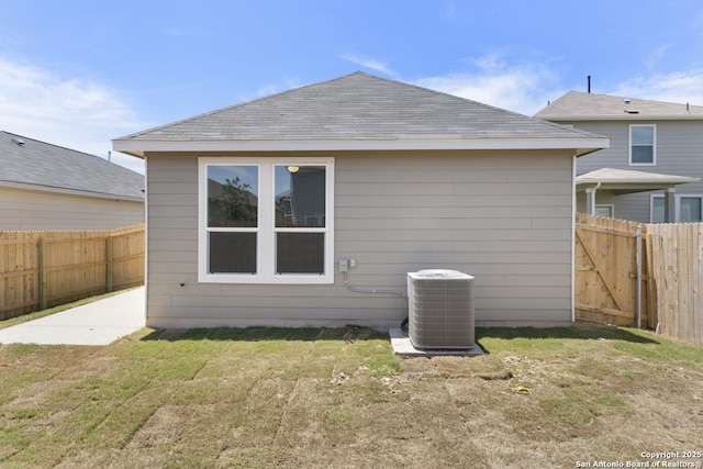 13210 Club House Blvd, San Antonio, TX 78221 - rear view of house with central air condition unit and a shingled roof