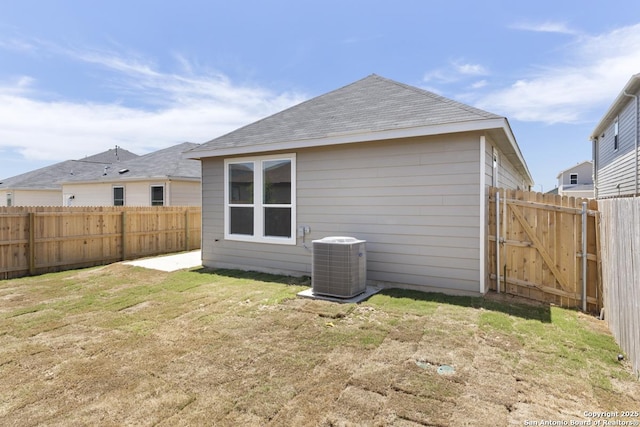13210 Club House Blvd, San Antonio, TX 78221 - back of house with central AC unit and a shingled roof