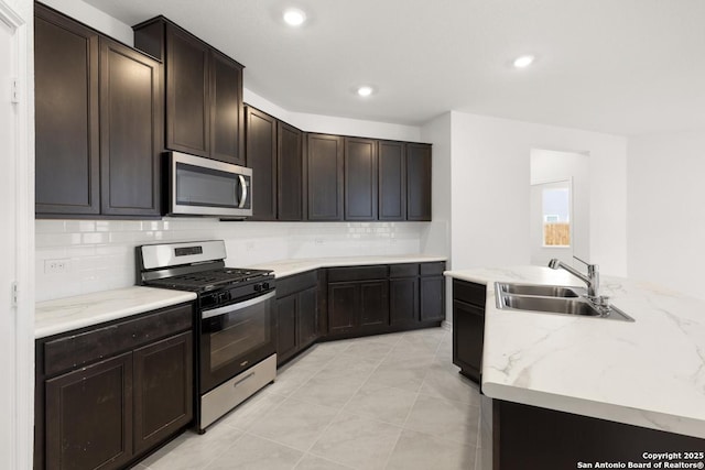 13210 Club House Blvd, San Antonio, TX 78221 - kitchen featuring stainless steel appliances, a sink, backsplash, recessed lighting, and dark brown cabinetry