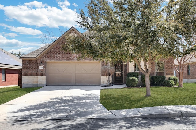 view of property hidden behind natural elements featuring stone siding, concrete driveway, an attached garage, a front yard, and brick siding