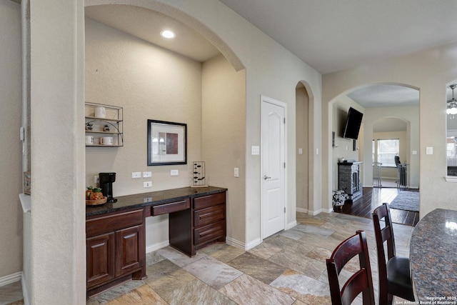 bathroom with stone finish floor and baseboards