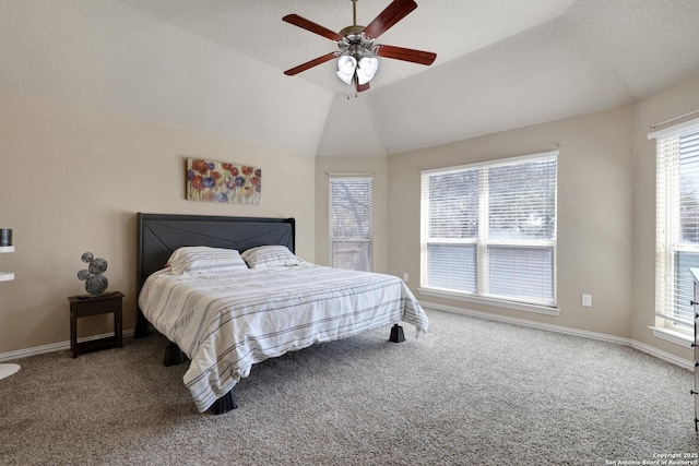 carpeted bedroom with lofted ceiling, a ceiling fan, and baseboards