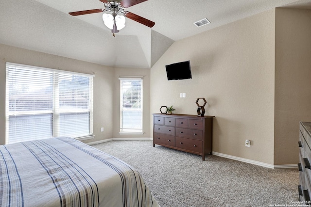 bedroom featuring visible vents, light colored carpet, baseboards, and vaulted ceiling