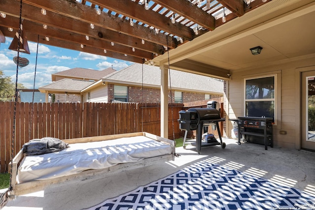 view of patio featuring a grill, a pergola, and fence