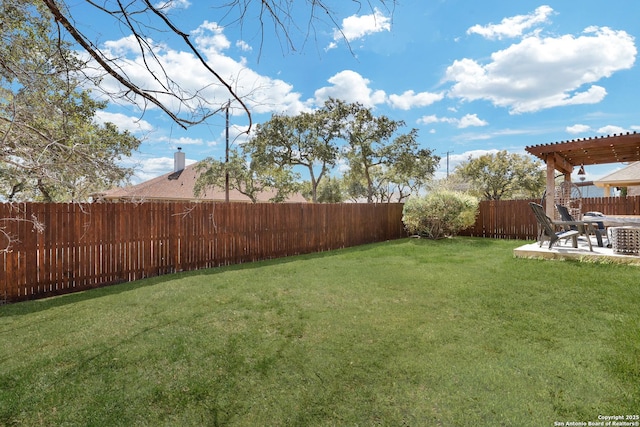 view of yard with a patio, a fenced backyard, and a pergola