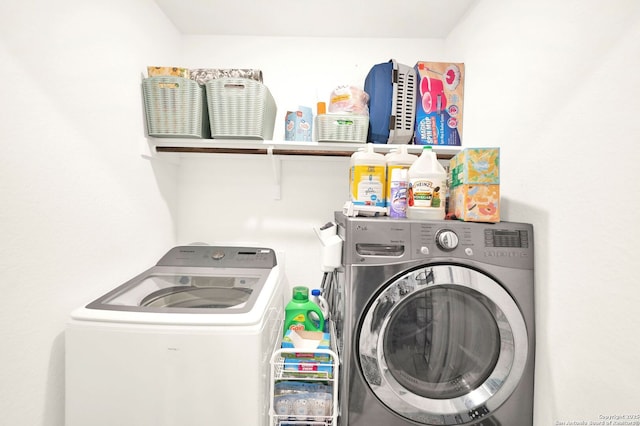 clothes washing area featuring laundry area and washing machine and dryer