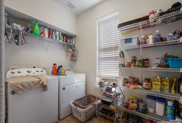 laundry area with laundry area, visible vents, independent washer and dryer, and a wealth of natural light