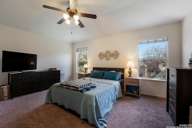 bedroom with ceiling fan, baseboards, and carpet