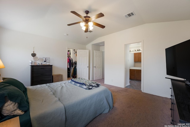 bedroom featuring carpet, visible vents, lofted ceiling, a closet, and a walk in closet