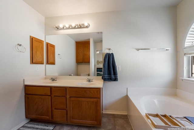 full bathroom with a sink, a garden tub, double vanity, and tile patterned floors