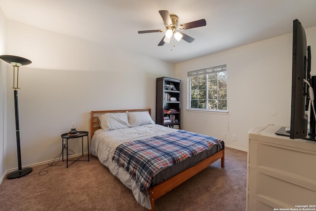 carpeted bedroom with a ceiling fan and baseboards