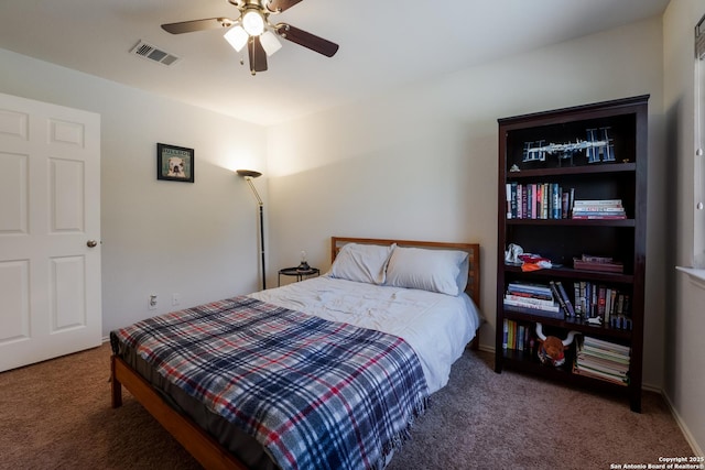 carpeted bedroom with visible vents and a ceiling fan