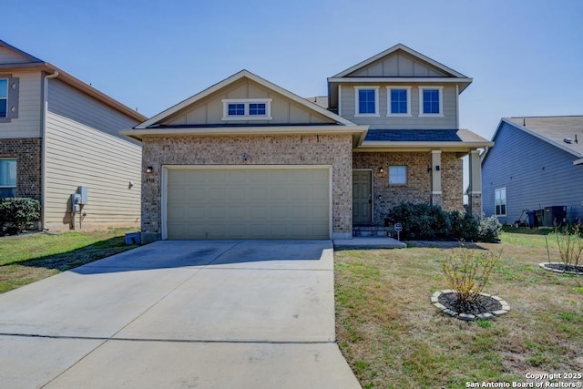 craftsman house with a front yard, concrete driveway, a garage, board and batten siding, and brick siding