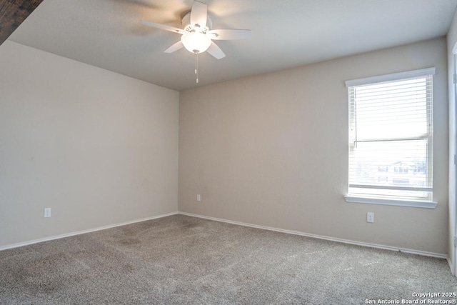 unfurnished room with a ceiling fan, baseboards, and carpet floors