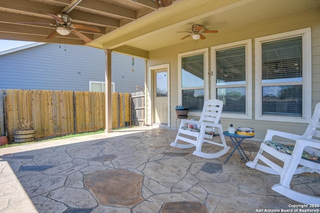 view of patio with fence and ceiling fan