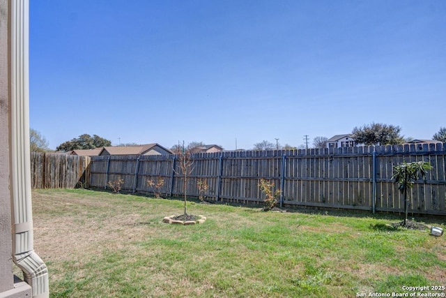 view of yard with a fenced backyard