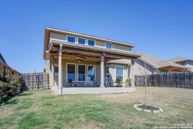 back of house with a yard, a fenced backyard, ceiling fan, and a patio area