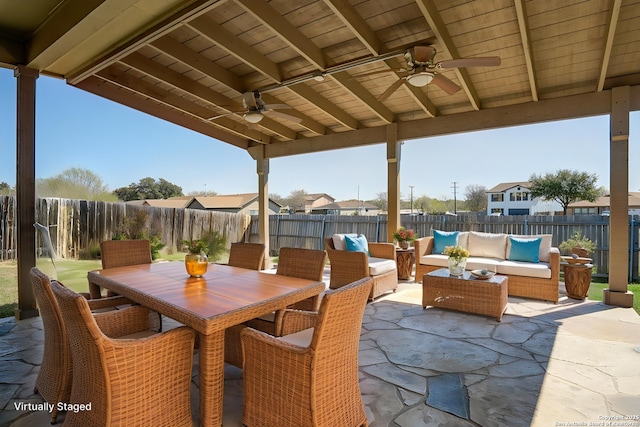 view of patio with ceiling fan, a fenced backyard, an outdoor hangout area, and outdoor dining space