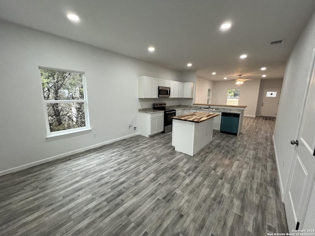 kitchen with visible vents, dark wood finished floors, white cabinets, appliances with stainless steel finishes, and open floor plan