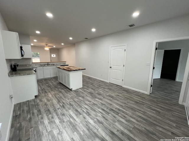 kitchen with visible vents, recessed lighting, white cabinetry, and wood finished floors