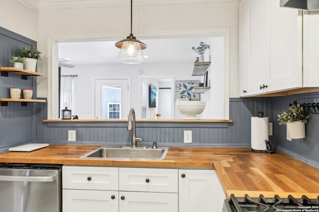 kitchen with a sink, dishwasher, wood counters, and open shelves