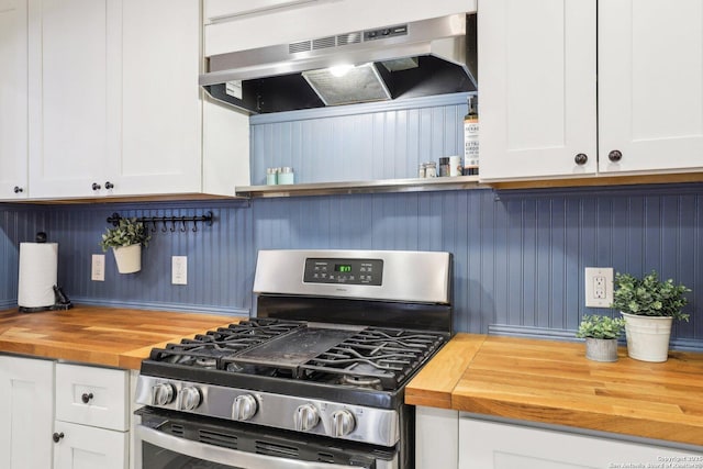 kitchen with white cabinetry, stainless steel range with gas stovetop, under cabinet range hood, and wood counters