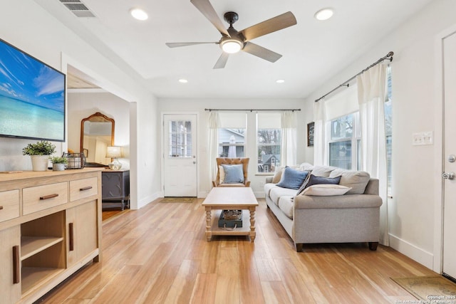 living area featuring recessed lighting, visible vents, baseboards, and light wood-style floors