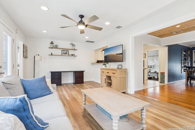 living area with light wood-style flooring, recessed lighting, and visible vents