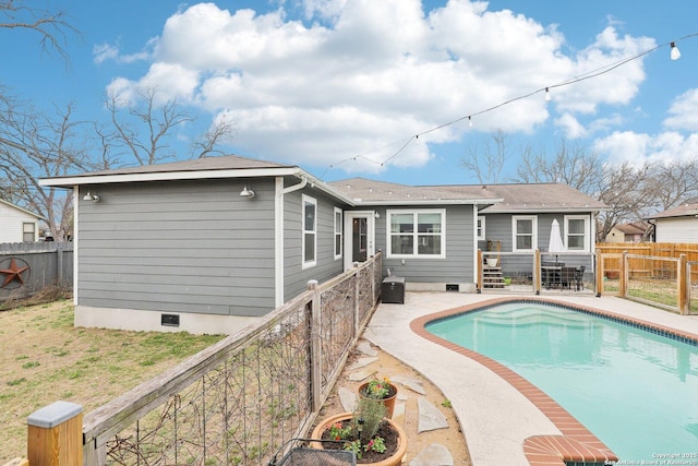 back of property featuring a patio, a fenced backyard, a fenced in pool, and crawl space