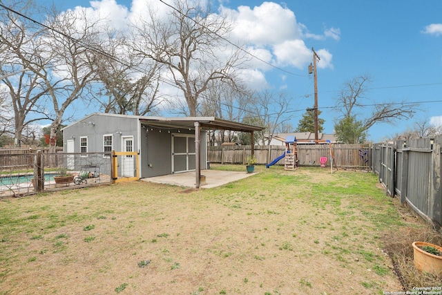 view of yard featuring a fenced in pool, a patio, a playground, and a fenced backyard