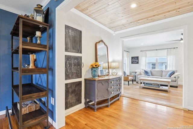 hall with wooden ceiling, wood finished floors, baseboards, and ornamental molding