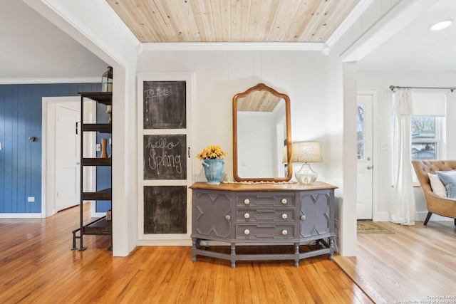 interior space with wooden ceiling, wood finished floors, and ornamental molding