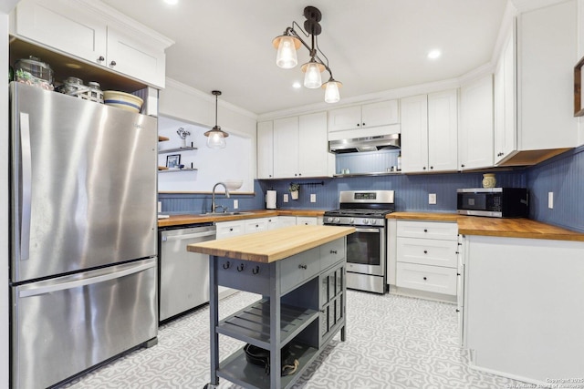 kitchen with open shelves, a sink, stainless steel appliances, under cabinet range hood, and butcher block counters