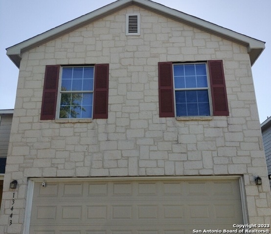 view of home's exterior featuring a garage and stone siding