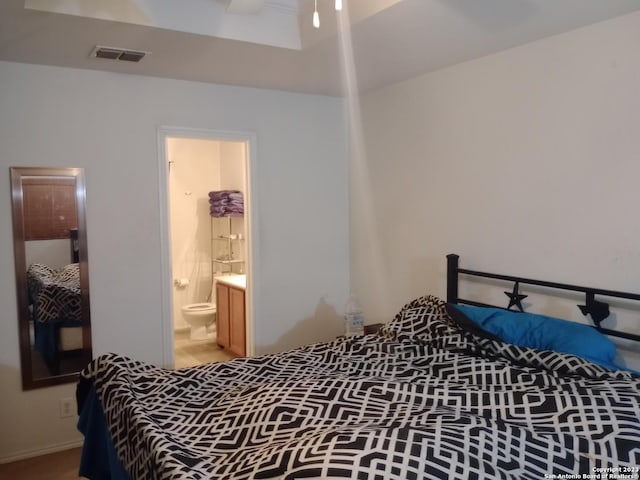 bedroom featuring visible vents and ensuite bath