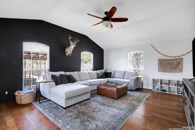 living area featuring hardwood / wood-style floors, lofted ceiling, and a healthy amount of sunlight