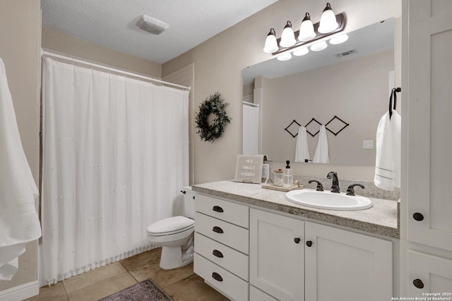 full bathroom featuring visible vents, toilet, a textured ceiling, tile patterned flooring, and vanity