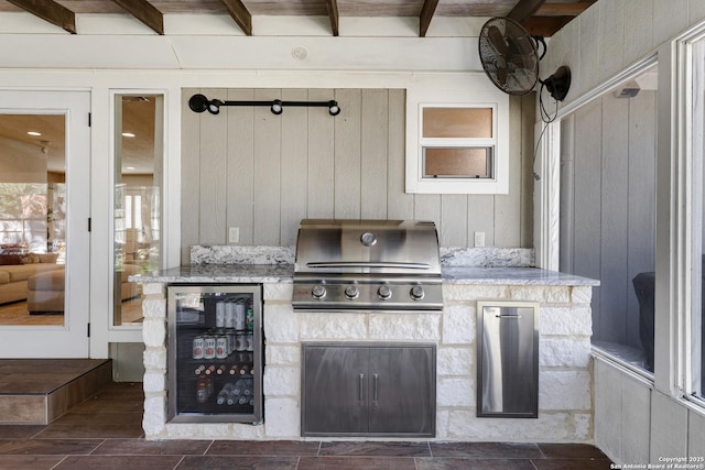 view of patio / terrace featuring wine cooler, area for grilling, and a grill