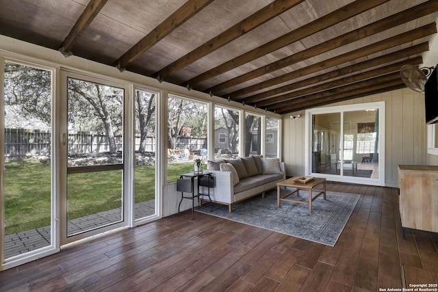 unfurnished sunroom featuring vaulted ceiling with beams