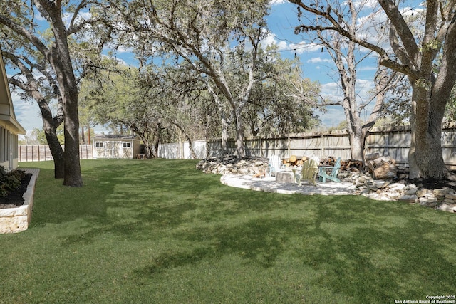 view of yard with an outdoor structure and a fenced backyard