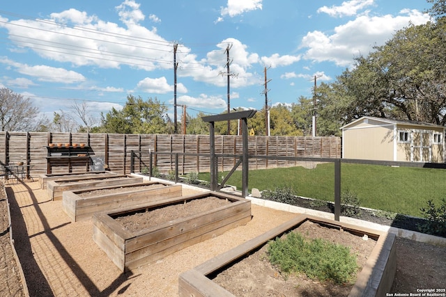 view of yard with an outbuilding, a garden, and fence